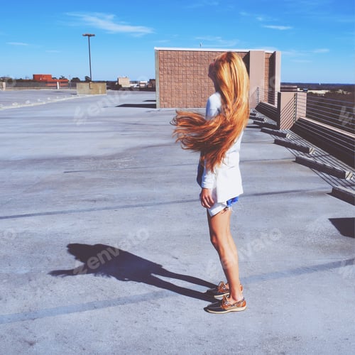 Preview: Woman with Long Hair on Concrete Rooftop