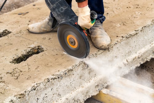 Preview: Close up worker cuts concrete with circular saw