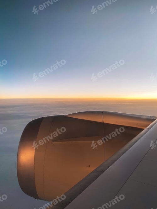 Preview: View from the airplane window on an aircraft engine at sunset.