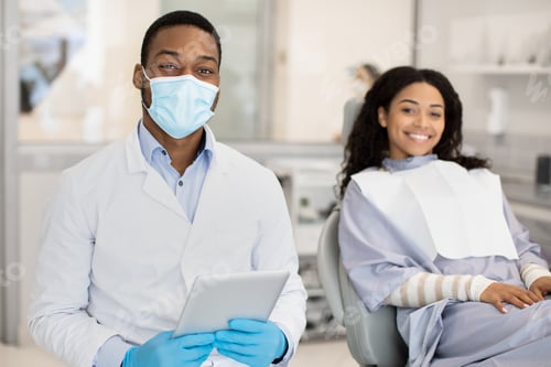 Preview: Dental Services. Black Dentist And Female Patient Posing In Modern Clinic Interior