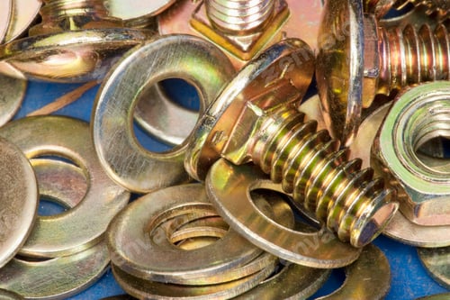 Preview: Close-up of yellow metal screws and washers.