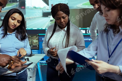 Preview: Diverse team of employees looking at cargo shipment logistics