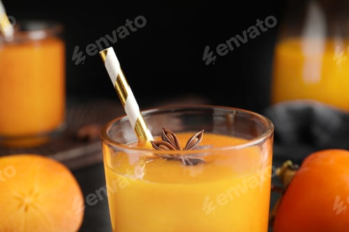 Preview: Tasty persimmon smoothie with anise and straw, closeup