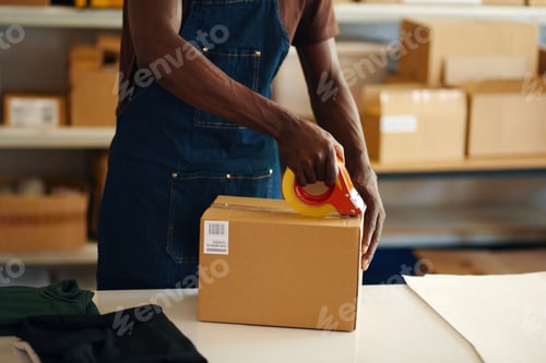 Preview: Worker Packing Parcel With Tape