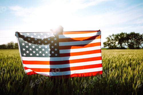 Preview: Man hold waving american USA flag. Patriot raise national american flag. Independence Day, 4th July.