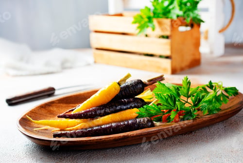 Preview: A bunch of carrots of different colors on a gray background.