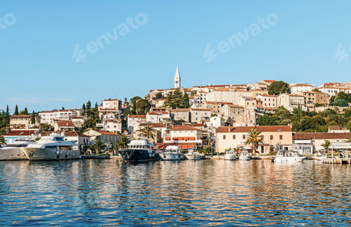 Preview: Boats and yachts in marina in front of picturesque seaside town on hill
