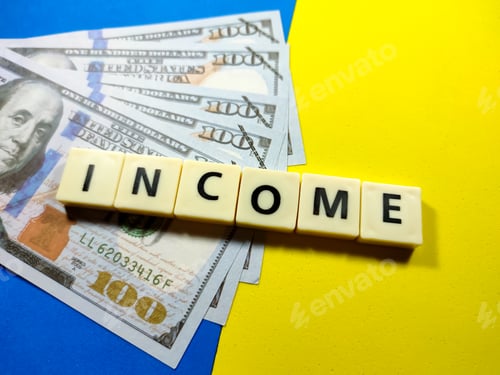 Preview: Banknotes with word income on blue and yellow background.Business concept.
