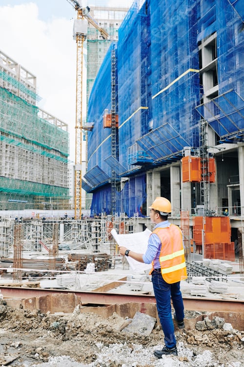 Preview: Engineer checking building blueprint