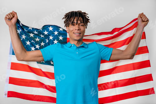 Preview: Happy african man with national USA flag. American patriot, 4th of July