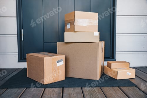 Preview: An Array of Brown Cardboard Boxes Stacked Neatly on a Doorstep, Showcasing Various Sizes