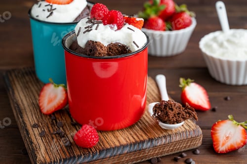 Preview: Chocolate mug cake with whipped cream and fresh berries. Cupcake cooked in the microwave.