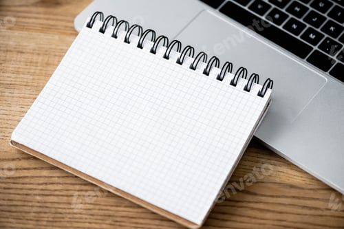 Preview: high angle view of notebook and laptop on wooden table