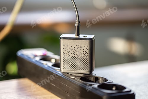 Preview: USB charging for gadgets on a blurred background of the room, close-up.