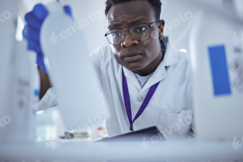 Preview: Ah hes found it. Shot of a young male scientist looking for a product in his lab.