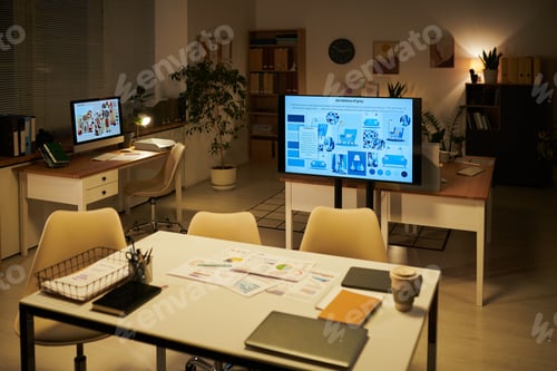 Preview: Empty Office Showing Business Presentation on Digital Screen at Night