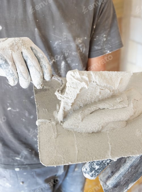 Preview: Plasterer Spreading Compound with Trowel Renovation Indoors