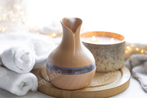Preview: Cozy composition with essential oil aroma diffuser, towels and candles.