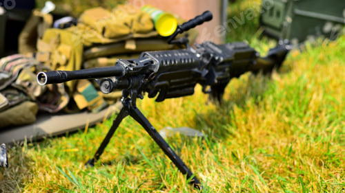 Preview: Closeup of a gun on green grass