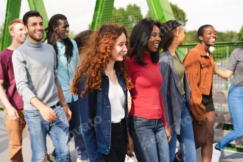 Preview: Group of multiracial people having fun outdoor laughing together