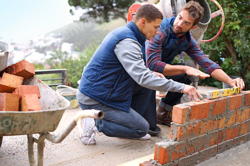 Preview: Making strong foundations - Teaching the basics. Shot of bricklayers at work.