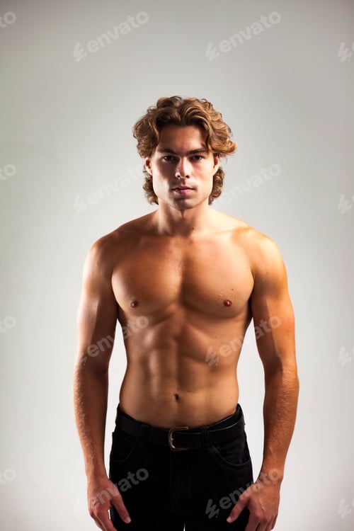 Preview: Portrait of handsome adult man muscular fashion model with abs press posing on grey