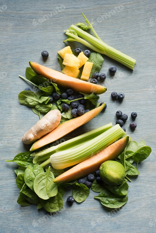 Preview: Fresh vegetables and fruits neatly arranged on a wooden background.