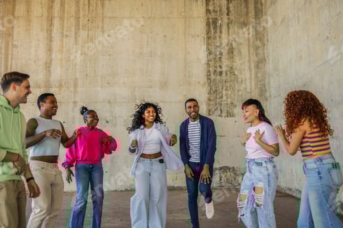Preview: Diverse group of young friends dancing and celebrating