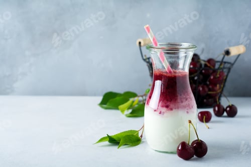 Preview: Fresh cherry smoothies in a glass jar on a light concrete background. Healthy eating, detox, diet fo