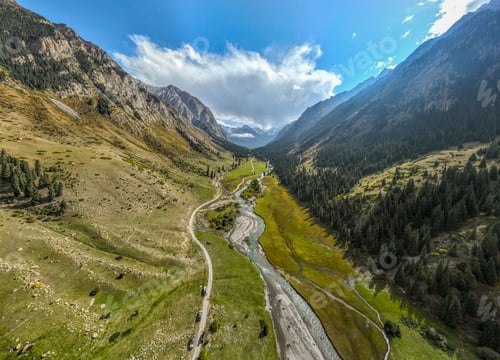 Preview: Epic aerial view of a lush green mountain valley with a river