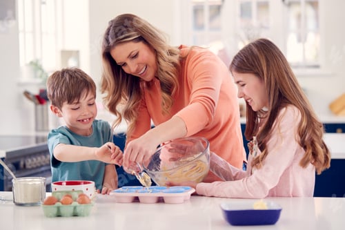 Preview: Mother With Two Children In Kitchen At Home Having Fun Baking Cakes Together