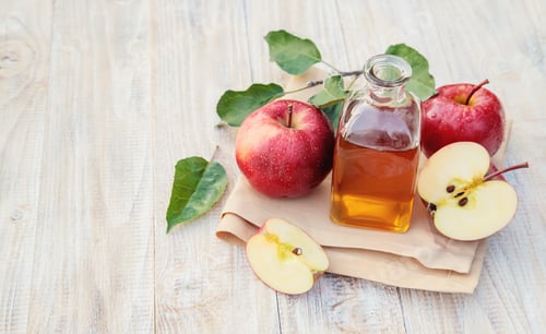 Preview: Apple cider vinegar in a bottle. Selective focus.