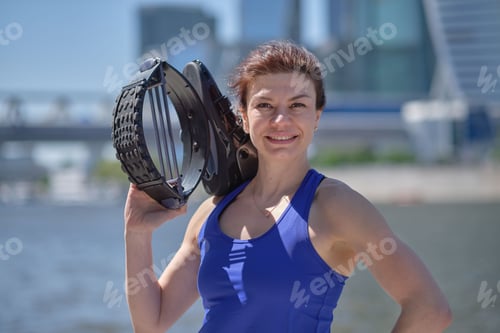 Preview: Sport female holding kangoo jumps. woman keeps kangoo jumping boots and smiling at camera.