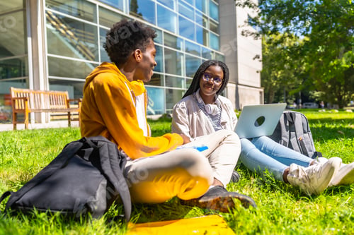 Preview: African colleagues studying together using laptop in the campus
