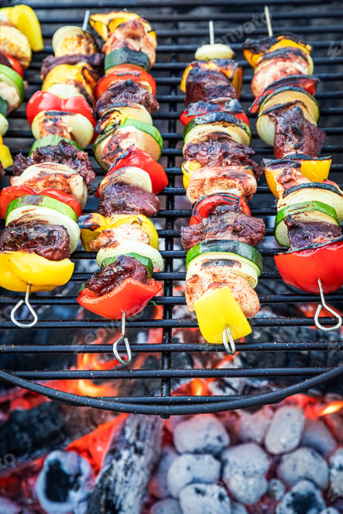 Preview: Homemade skewers on grill with meat. Grill in garden.