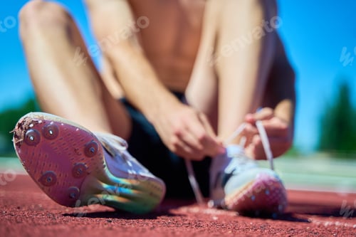 Preview: A man is sitting on the ground with his feet up