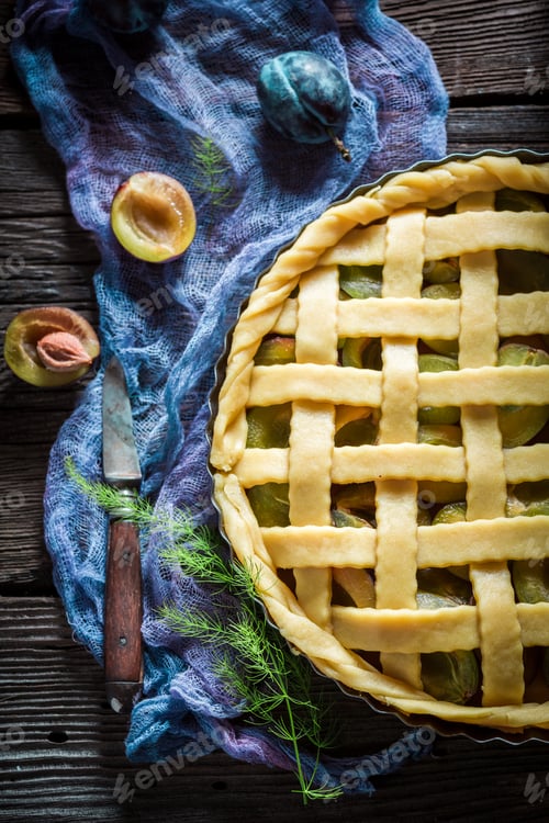 Preview: Sweet and tasty plum pie on blue cloth