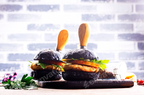 Preview: Tasty craft burger with black bun on the board