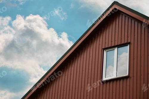 Brown House with Clouds and Blue Sky