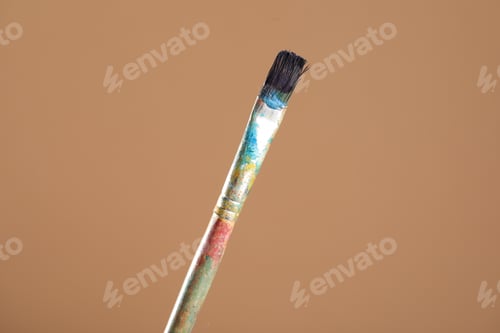 Preview: Dirty paintbrush on light brown background, closeup