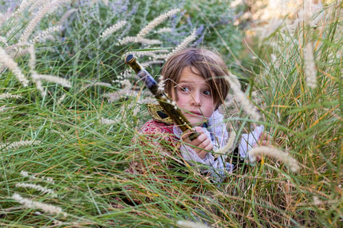 Preview: Young boy dressed as a pirate holding long pistol.