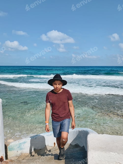 Preview: Boy walking on the beach shore