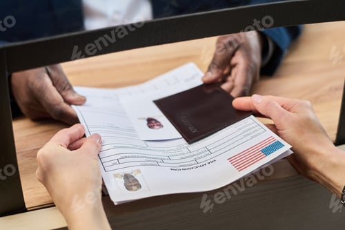 Preview: Woman Handing Visa Application Documents to Black Man at Visa Center