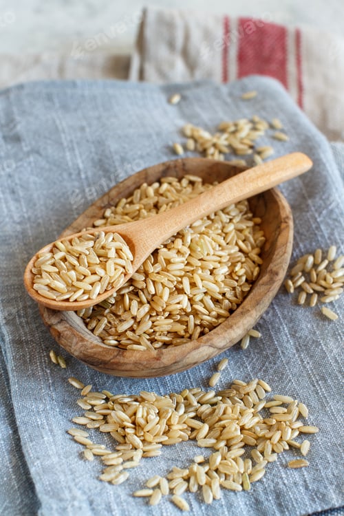 Preview: Brown rice in a wooden bowl with a spoon