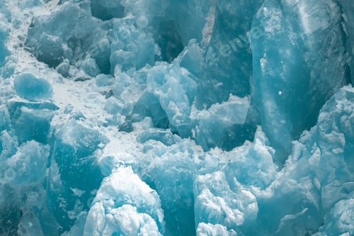 Preview: Closeup shot of the ice texture of a blue glacial wall in Inside Passage, Alaska