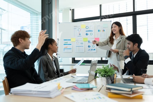 Preview: Business people discussing documents and ideas at meeting