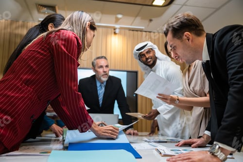 Preview: Group of multi-Ethnic businessman and businesswoman working in office.
