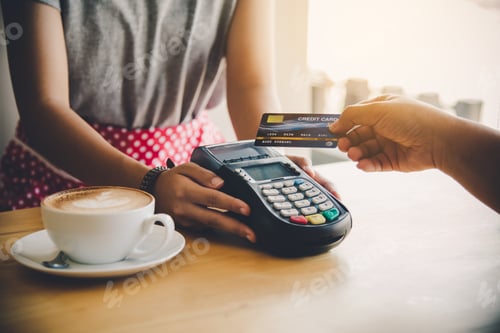 Preview: Close up of hand using credit card to pay by sending the credit card