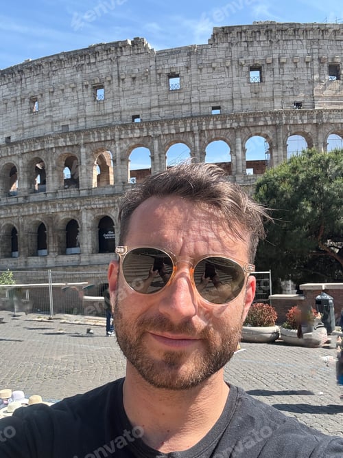 Preview: A man wearing sunglasses coliseum at the background