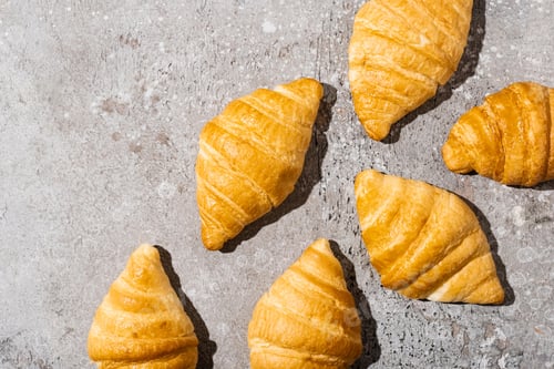 Preview: Top View of Fresh Baked Croissants on Concrete Grey Surface
